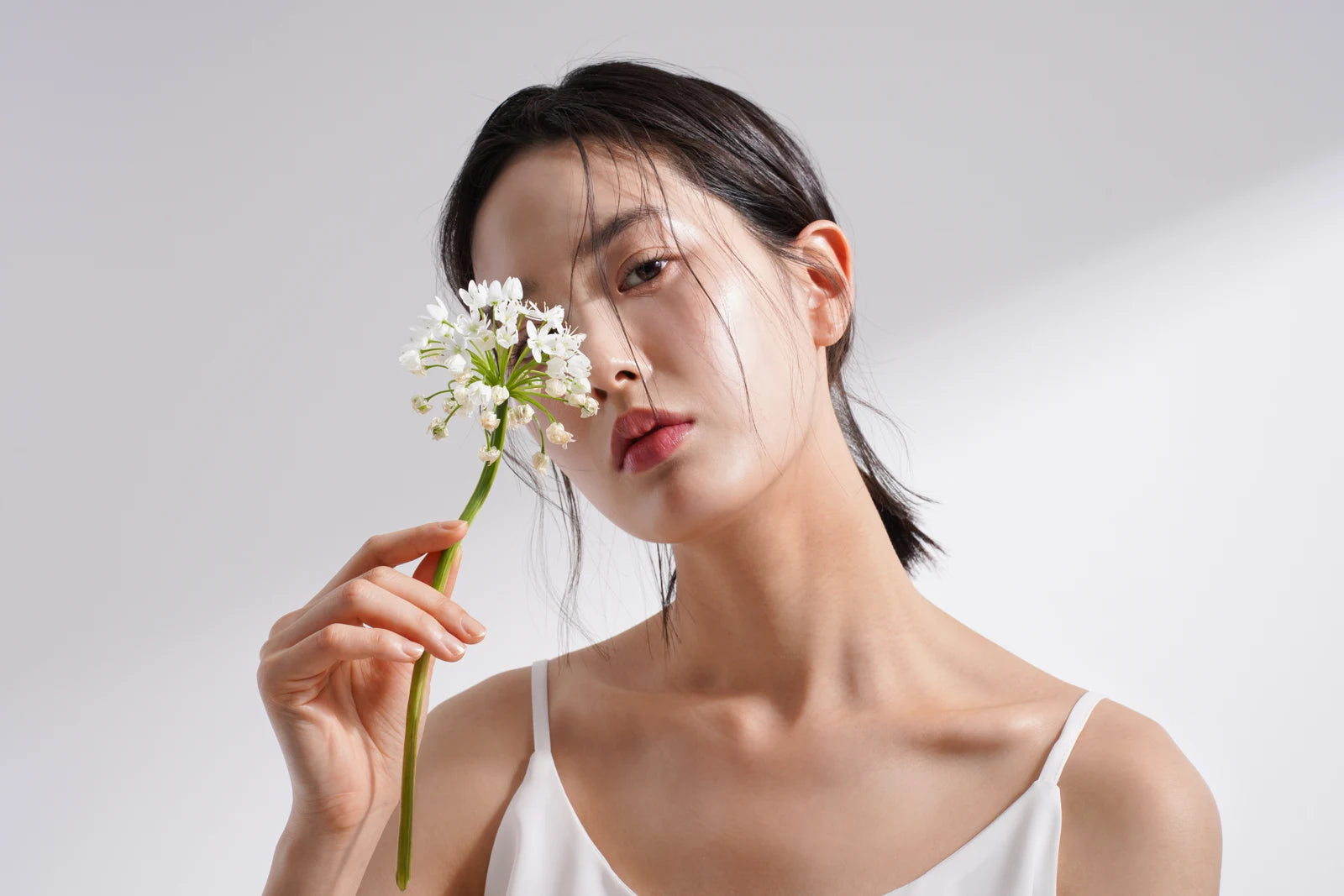 Woman holding white flowers in natural light